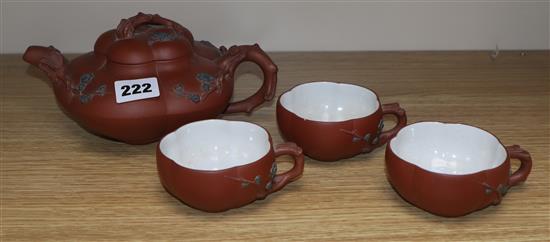 A Yixing pottery teapot and three cups